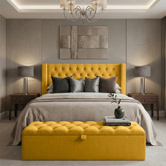 Modern bedroom with yellow upholstered bed and bench, gray bedding, and abstract art on the wall.