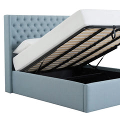 Light blue tufted storage bed with gas lift base fully open, showing spacious storage compartment and wooden slats