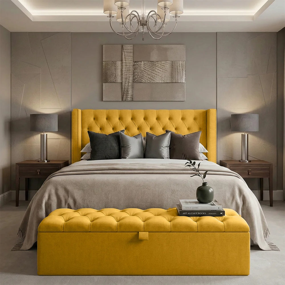 Modern bedroom with yellow upholstered bed and bench, gray bedding, and abstract art on the wall.