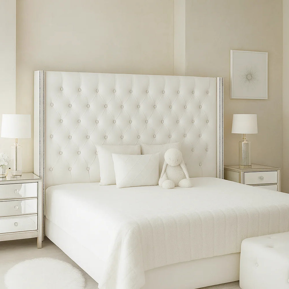 Serenity Royale Storage Bed in white with luxury tufted wingback headboard, crystal button detailing, and elegant mirrored nightstands in a bright modern bedroom