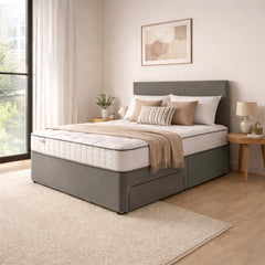 Gray upholstered bed with white mattress in a bedroom setting.