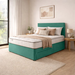Teal bed frame with beige bedding in a bedroom setting